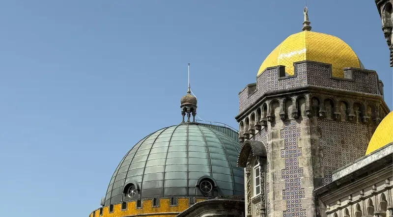Green and yellow domes of Pena Palace seen close up in Sintra