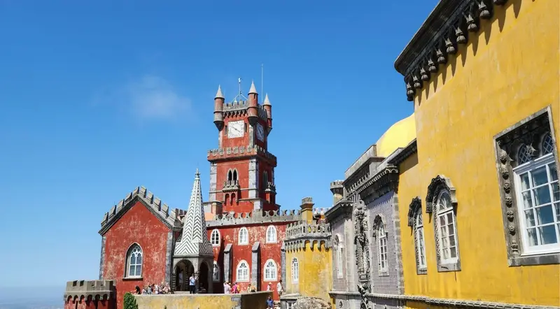 Pena Palace courtyard with red tower and yellow tiled walls in Sintra