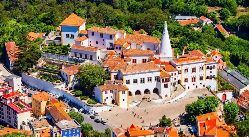 Historic centre of Sintra with the twin conical chimneys of the National Palace and red rooftops